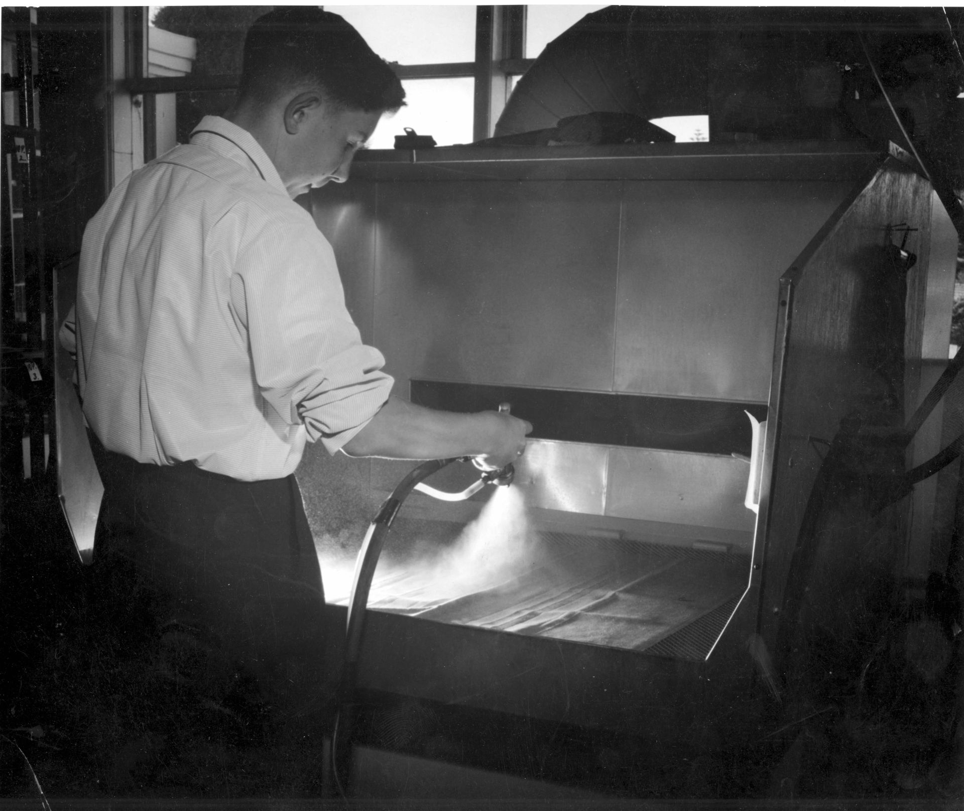 Applying the Siro by hand in a spray booth at FJs, 1962.  Photo: Jones Family Collection