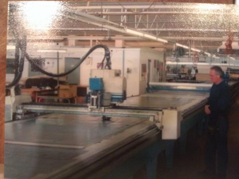 "This is the last trouser lay cut at FJs cutting room on 17th September 2004. It's my dad in the photo, Neville Boswell. He worked there for 37.5 years from 1967 to the last day!    My dad was driving the Gerber, which was an electronic computerised cutting machine that held the pattern for the trousers and then it used a blade to cut them out. There is plastic over the fabric and it was moved with air and vacuum suction."  Shared by Janis Bennet