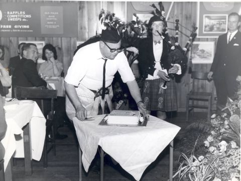 Placing the cake.  On the right, next to the piper is Chic Phillips.   Photo: Alex Wilkins. Shared by Yola Bennoun. 