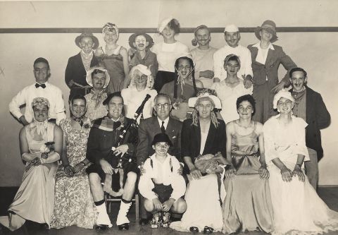 FJ Staff in fancy dress. Back row from left Merv Dowd, Frank Green, Jim Kelly, Graham Boyle, Les Swan, Bob Turner, Ron Oakley. Middle row - from left Chic Phillips, Edgar Hoy, Colin Wayne, Fred Ballinger, George Beasley, Ray Haberfield. Front from left Andy Trench, Lindsey McEwan, George Dorian, Fletcher Jones, Horie Verey, Lawson Ryan and Allan Carter. In front Ray Ryan - Lawson's son. Photo: Alex Wilkins and names supplied by Lawson Ryan