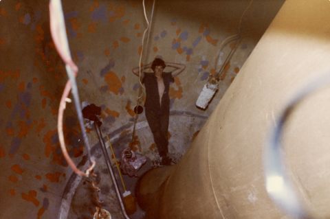 Gary Kelly 'relaxing' in the bottom of the ball. He is standing beside the outlet which can be seen just to the left of his hip. To the left and right of him hang the anodes that were electrified and designed to attract rust.  The red cord carried the minimal electric charge.  Photo: Gary Kelly