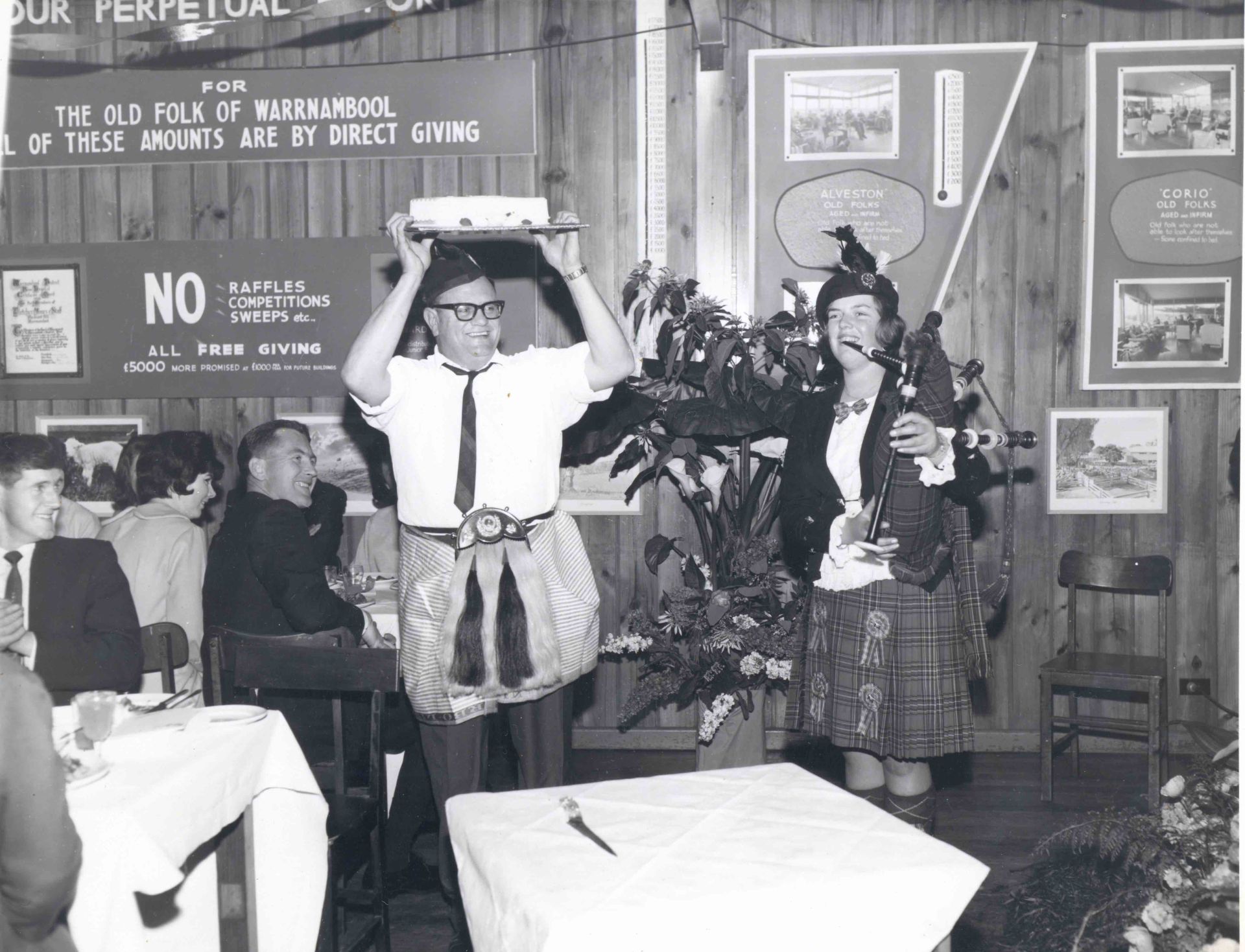 Dancing with the cake, Maurice Bennoun and unknown piper.  Photo: Alex Wilkins